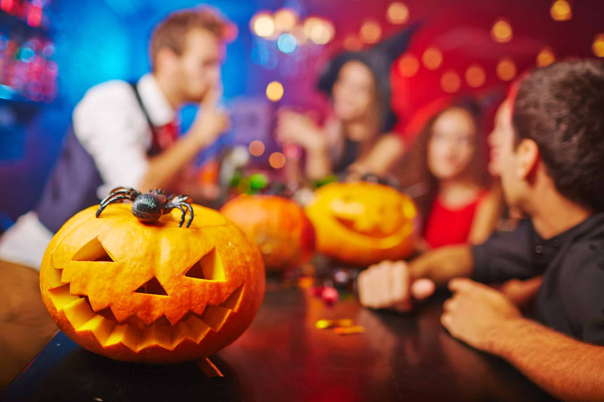 Jack-o-lantern,On,Bar,Counter,And,Friends,On,Background